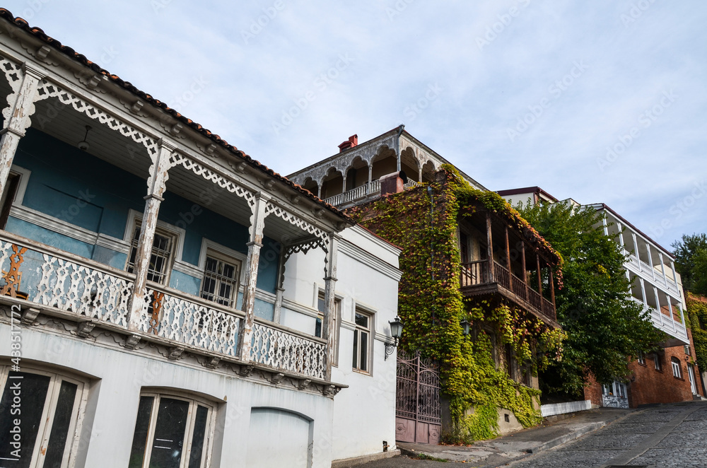 Authentic Georgian houses with wooden balconies overgrown with grapes in the old center of Tbilisi, Georgia 