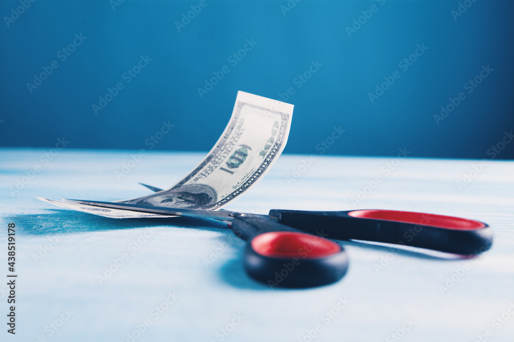 money and scissors on the table money and scissors on the table