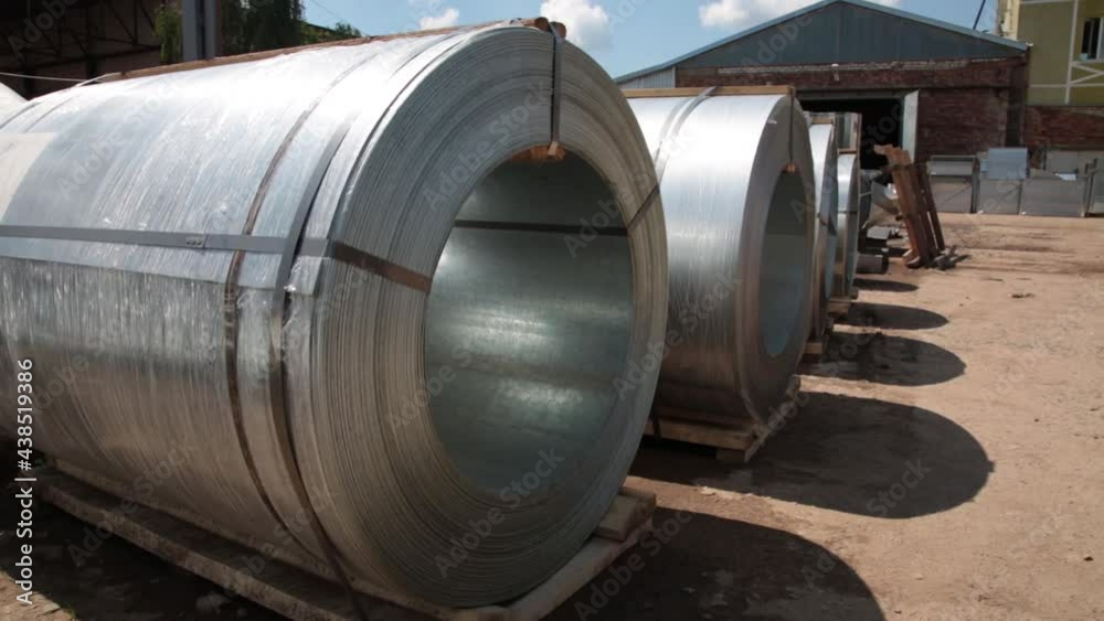 Stainless steel rolls. Rolls of steel sheet in the warehouse. A roll of galvanized steel sheet for the production of metal pipes and tubes in a factory. Stainless steel rolls. Rolls of steel sheet in the warehouse. A roll of galvanized steel sheet for the production of metal pipes and tubes in a factory.