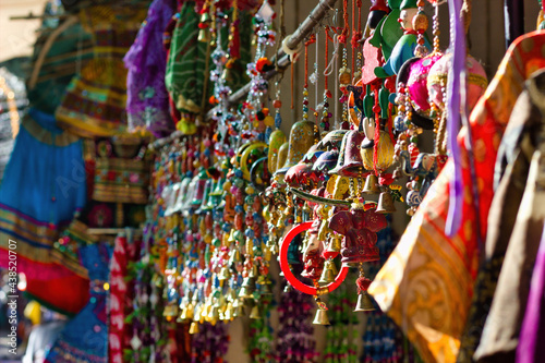 Bunch of colorful decorative item as souvenir being hanging as display for sale in the commercial street of pushkar fair in the state of Rajasthan