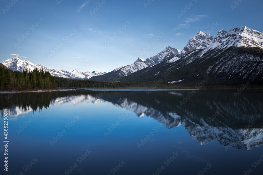 Reflection of the Canadian Rocky Mountains in the still water of the Goat Lake in Kananaskis Provincial Park