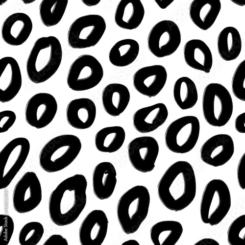 Seamless pattern with abstract black circles on white. Animal skin imitation. Texture for print, fabric, textile, wallpaper.