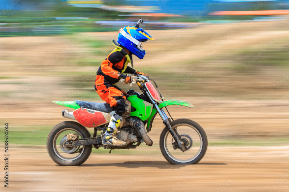 Motion blur of motocross rider in motocross competition Motion blur of motocross rider in motocross competition