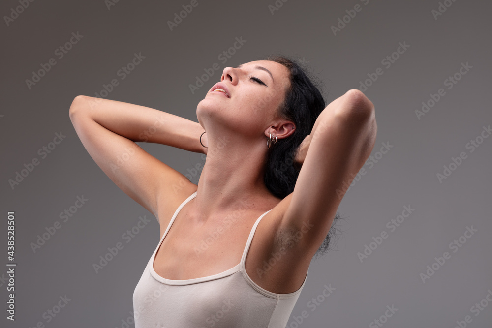 Serene young woman stretching back her head with parted lips Serene young woman stretching back her head with parted lips