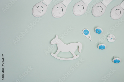 Child protection for furniture. Child protection devices on blue background. Protection of outlets, boxes, corners, doors.Flat lay with copy space. photo
