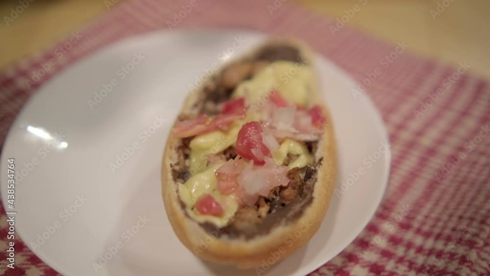 Traditional Mexican mollete on a plate above white and red checkered napkin Traditional Mexican mollete on a plate above white and red checkered napkin