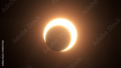 Annular Solar Eclipse — 3D illustration render moon crossing in front of the sun. Partial dark ring of fire in space and sky. photo
