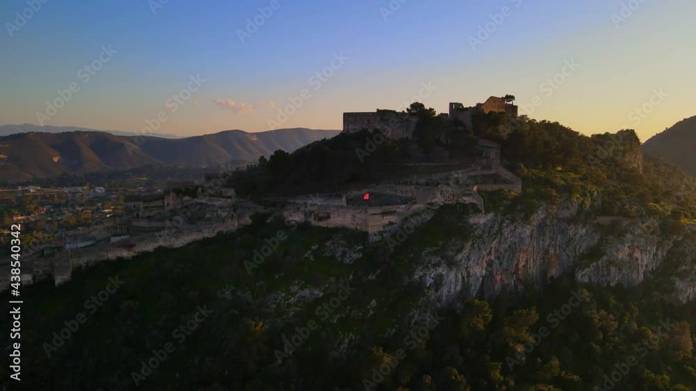 The impressive walls of the castle of Xátiva on the mountains illuminated by the sun. The impressive walls of the castle of Xátiva on the mountains illuminated by the sun.