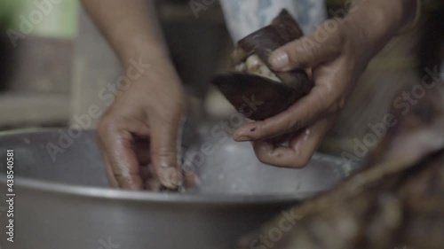 Pig ear for Hok Khana Kasathei chutney is scraped and washed in India photo