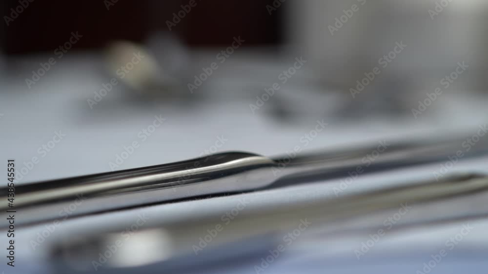 Setting a table, close-up of placing silverware on the table.