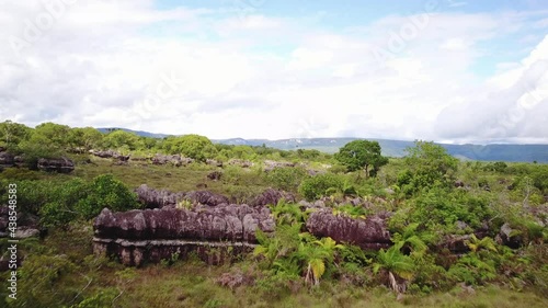 Beautiful aerial shot flying low over Colombian nature with trees and mountains photo