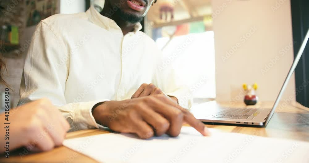 Affectionate mixed race couple going through paperwork. African man and latin woman calculating bills Affectionate mixed race couple going through paperwork. African man and latin woman calculating bills