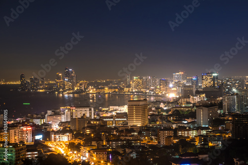 The bay and skyscrapers in twilight time and midnight time in Pattaya, Thailand. Pattaya city is famous for sea sport and night life entertainment.