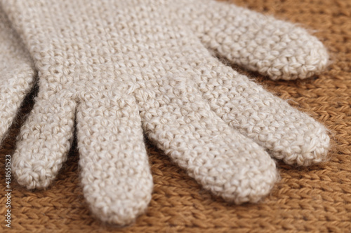 Close-up detail of part of cream-colored wool glove, crocheted. Winter clothing. © Ri Fotoproducto