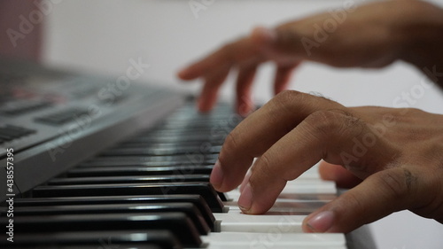 Man hand playing electronic piano