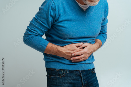 Handsome senior  isolated on grey background. Old man feeling pain. Concept about the third age and seniority photo