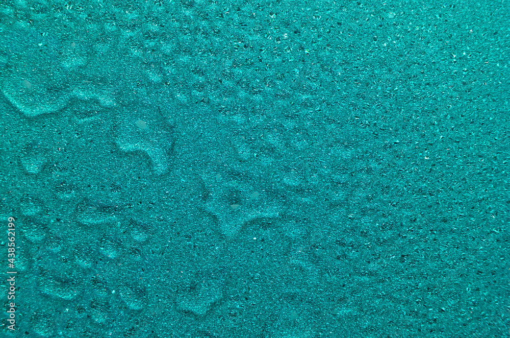 Blue aqua shimmer glitter wet texture with drops and ripple. Fresh lagoon abstract background.