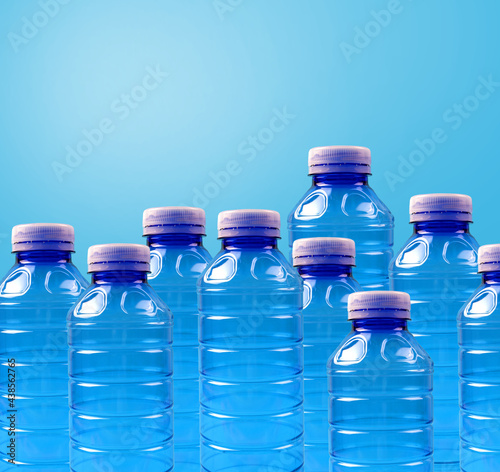 Plastikowe butelki na czystym błękitnym tle. Baner z miejscem na tekst.