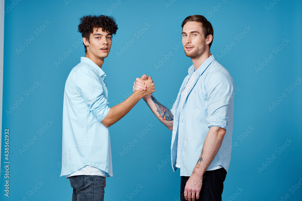 good friends in shirts on a blue background communication greeting party good friends in shirts on a blue background communication greeting party