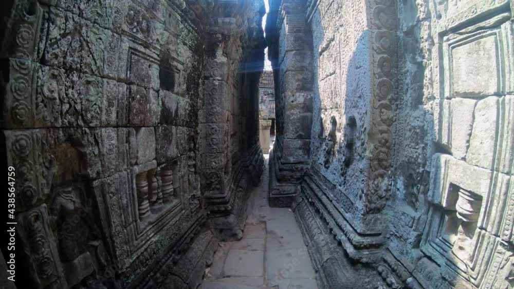 Walking through a stone temple in Siem Reap, Cambodia. Different cravings on the walls, fallen columns. Walking through a stone temple in Siem Reap, Cambodia. Different cravings on the walls, fallen columns.