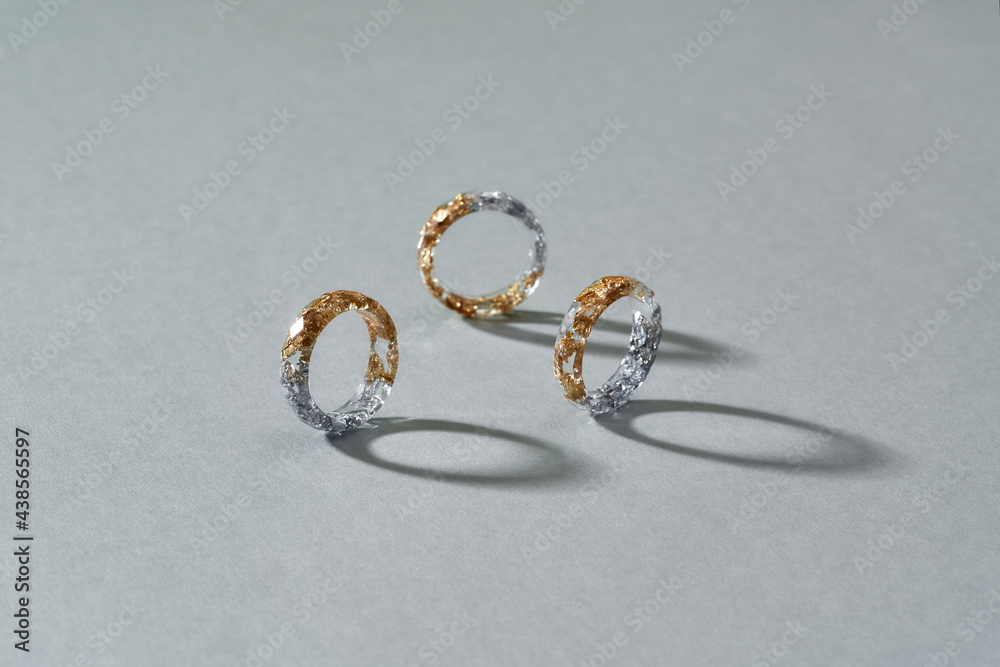 Transparent acrylic rings with half golden and silver filling Transparent acrylic rings with half golden and silver filling