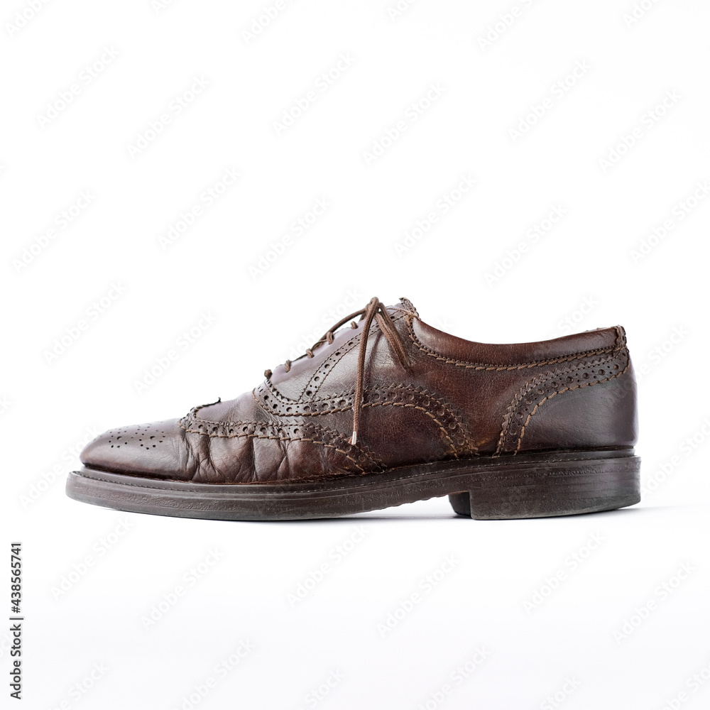 old worn brown men's brogues on a white background close-up side view. classic men's shoes. mockup old worn brown men's brogues on a white background close-up side view. classic men's shoes. mockup
