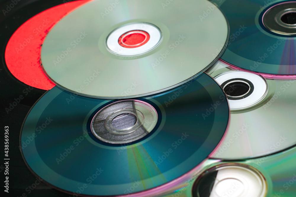 vinyl discs and CDs on a white surface concept storage of information progress vinyl discs and CDs on a white surface concept storage of information progress