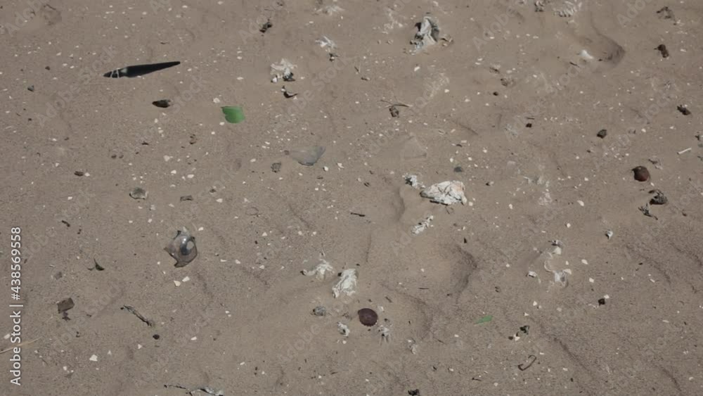 Sand dunes full of plastic bags and bottles, scattered household waste Sand dunes full of plastic bags and bottles, scattered household waste