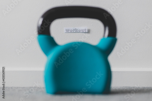 home gym and exercising in your spare time, kettlebell on the floor with Workout message
