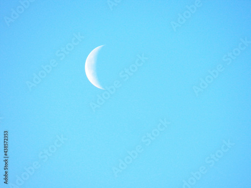 A crescent of moon high in the left of my sky in a 4x3 photography photo