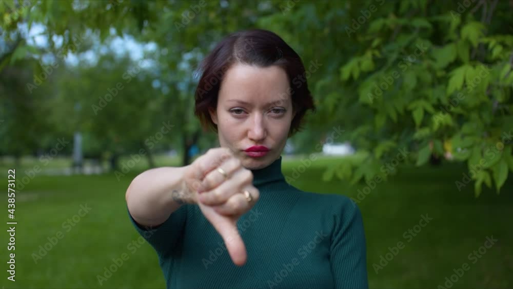 Woman shows thumbs down sign. Gestures and Language of body Woman shows thumbs down sign. Gestures and Language of body