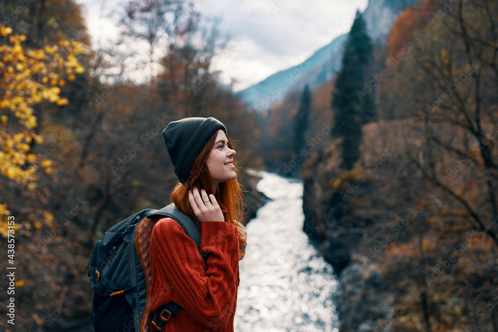 cheerful woman Tourist of all the law admires the nature of the mountain river cheerful woman Tourist of all the law admires the nature of the mountain river
