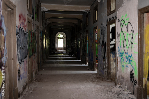 Old abandoned building in ruins, it is a dangerous site with graffiti © Adolf