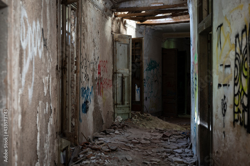 Old abandoned building in ruins, it is a dangerous site with graffiti