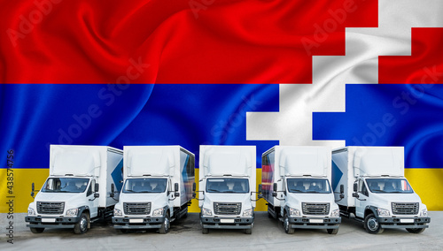 Arcah flag in the background. Five new white trucks are parked in the parking lot. Truck, transport, freight transport. Freight and logistics concept photo