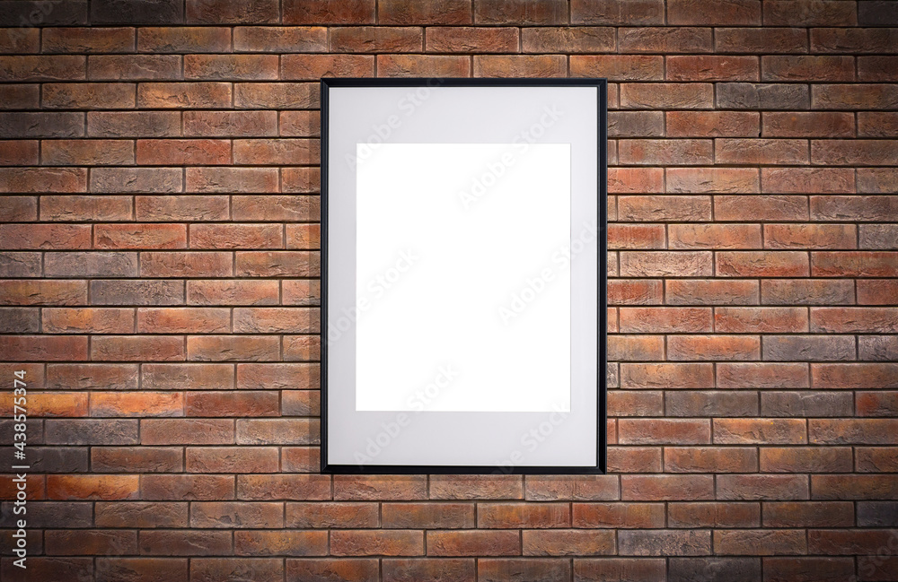 Mock up poster frame in interior wall. White frame for poster or photo image on brick loft wall in home room or office interior Mock up poster frame in interior wall. White frame for poster or photo image on brick loft wall in home room or office interior