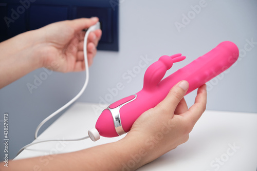 Woman's hand plugging in her dildo © Ladanifer