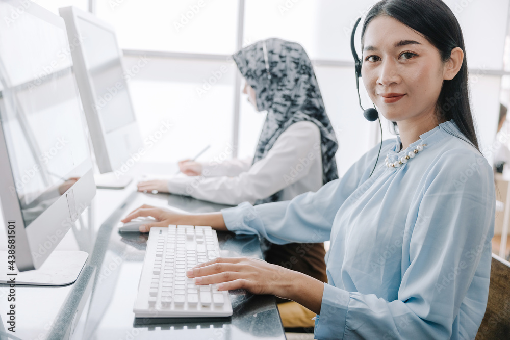 secretary operator wears a headset and microphone for consultant assistance support, the call center staff providing advice and assistance customers in smiling and happy manner while looking at camera secretary operator wears a headset and microphone for consultant assistance support, the call center staff providing advice and assistance customers in smiling and happy manner while looking at camera
