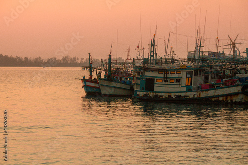 Scenic view of a group of Cambodian fishing boats in mooring against the sunset sky in Koh Sdach Island Cambodia