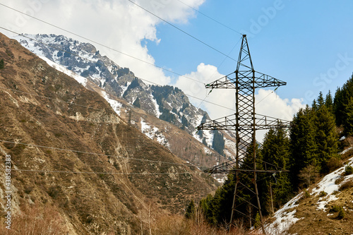 metal mast of a high-voltage power line on the background of mountains © Temir