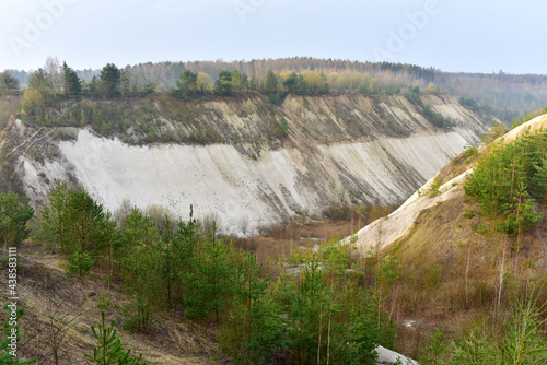 Chalk structure on artificial mountain after quarry mining. Technogenic rock formed during mine. Mountain hill with chalk fossil and limestone. Mining geology. Canyon with mountains in open pit