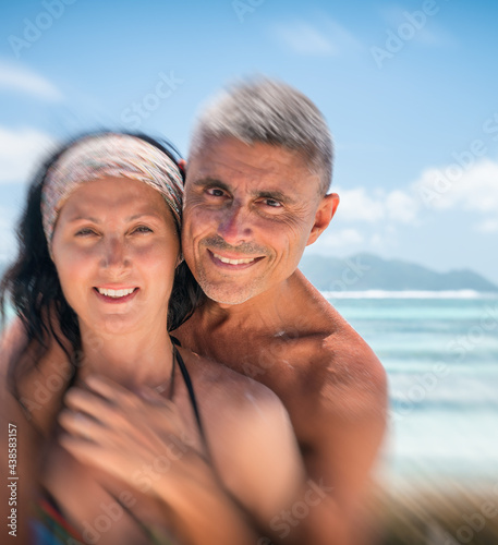 Beautiful couple in 40s relaxing along La Digue rocks, Seychelle © jovannig