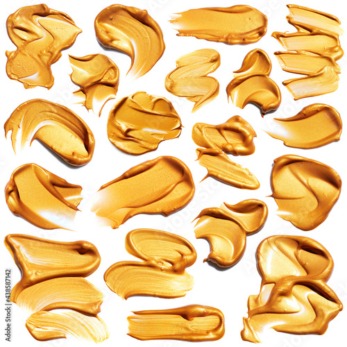 Set of golden paint smudges isolated on white background