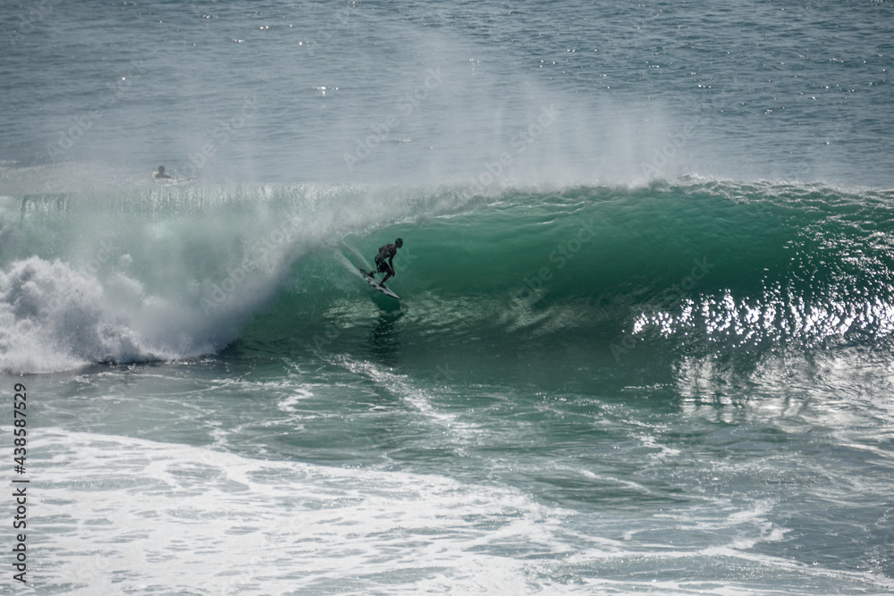 Surfer on perfect blue wave, in the barrel, clean water, Indian Ocean .