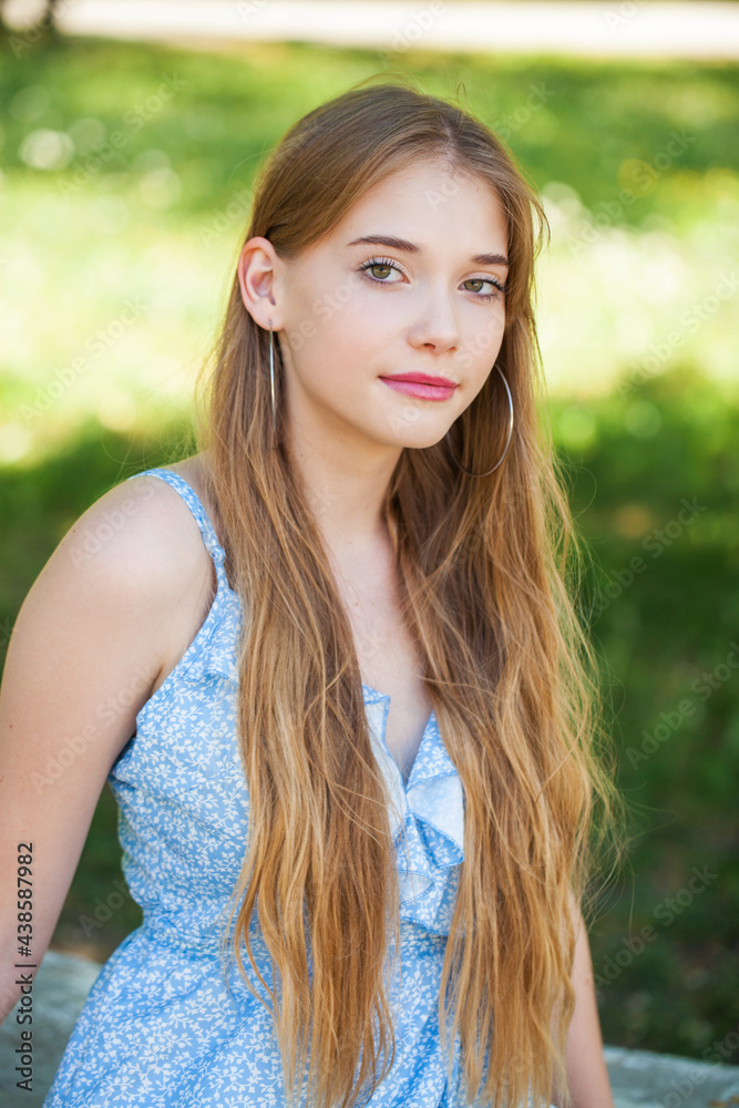 Portrait of a teenage girl on the background of a summer park Portrait of a teenage girl on the background of a summer park