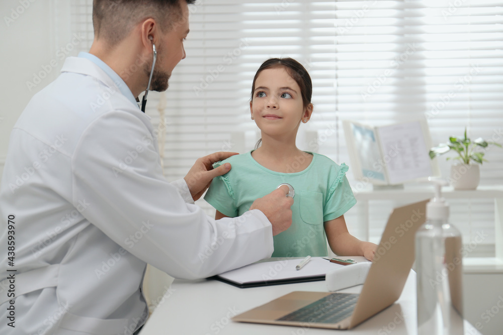 Pediatrician examining little girl in office at hospital