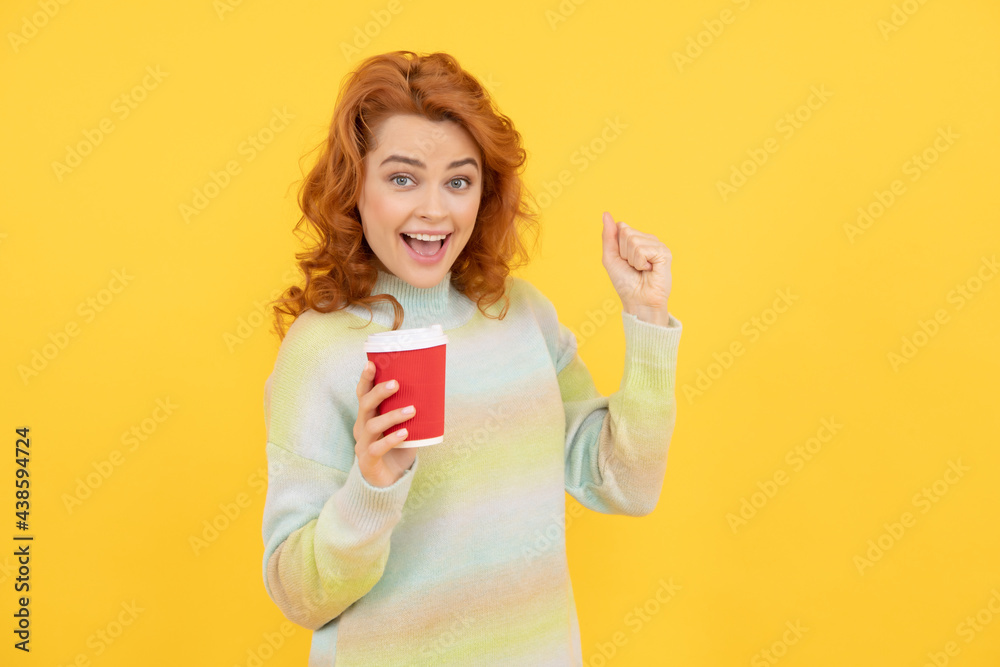 happy redhead girl drink takeaway coffee from cup on yellow background, morning happy redhead girl drink takeaway coffee from cup on yellow background, morning
