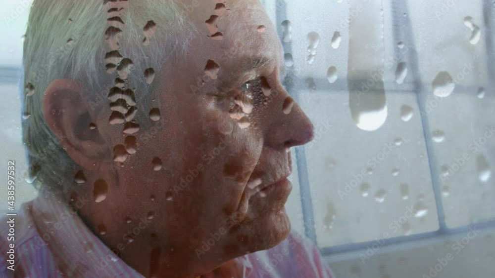 Animation of water drops on glass over worried senior man Animation of water drops on glass over worried senior man