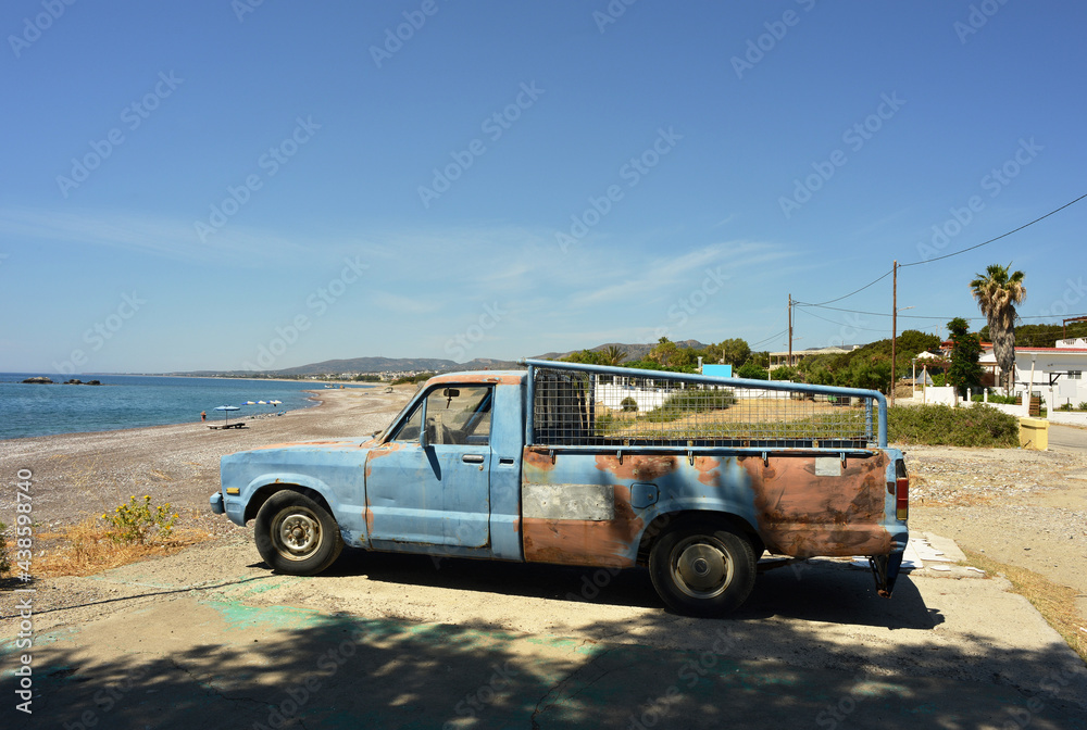 Old Pickup truck on the beach of Kiotari, Rhodes, Greece Old Pickup truck on the beach of Kiotari, Rhodes, Greece