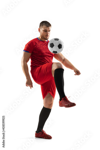 Powerful  flying above the field. Young football  soccer player in action  motion isolated on white background .